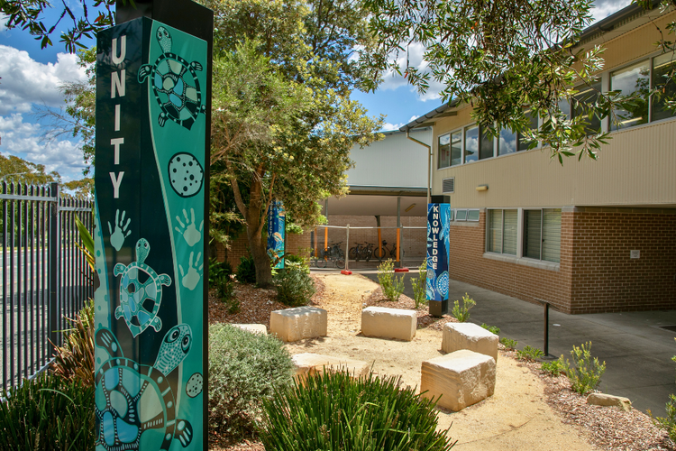 Welcome poles in the Yarning circle