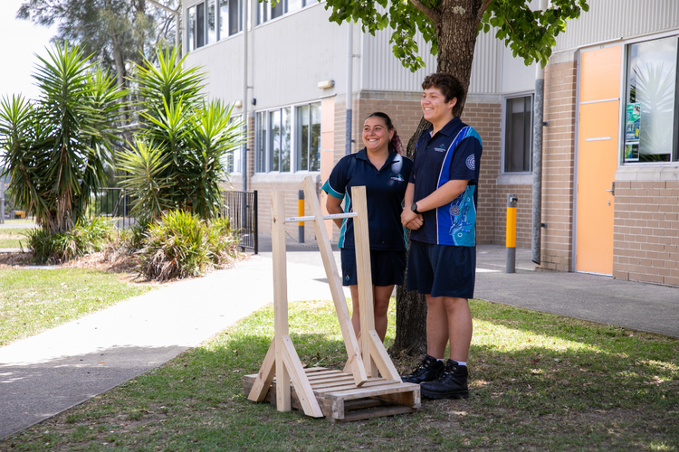 Students displaying timber project outside