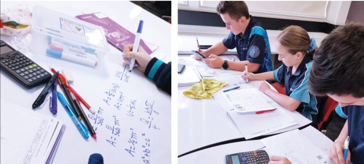 close up of mathematics calculation on desk and students working in class