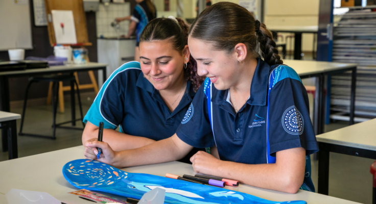 Girls creating skateboard art